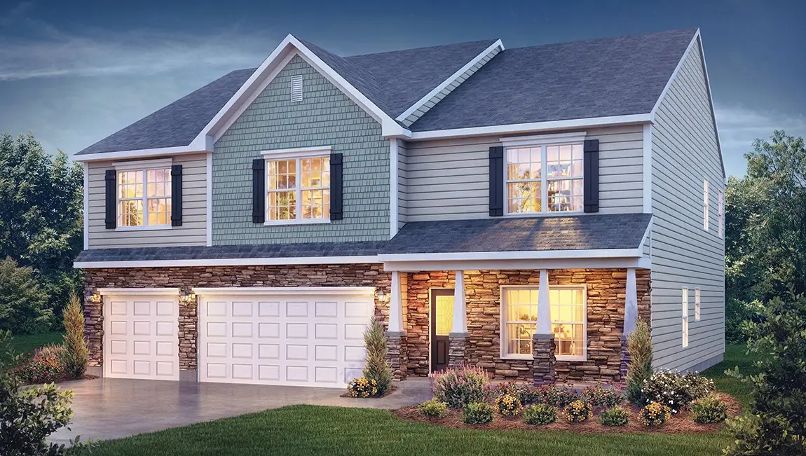 Two-story home with a stone front porch and three-car garage at dusk