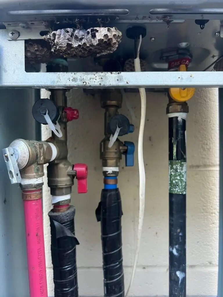 Hot and cold water service valves installed beneath a tankless water heater