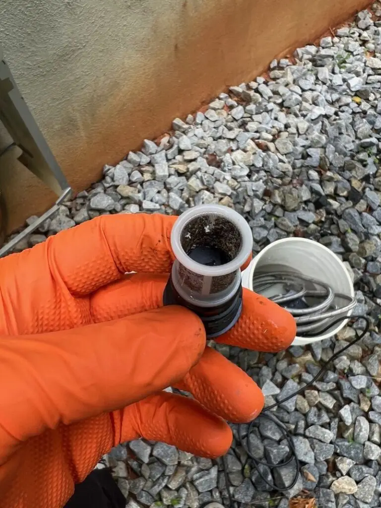 Tankless water heater inlet filter screen with sediment buildup