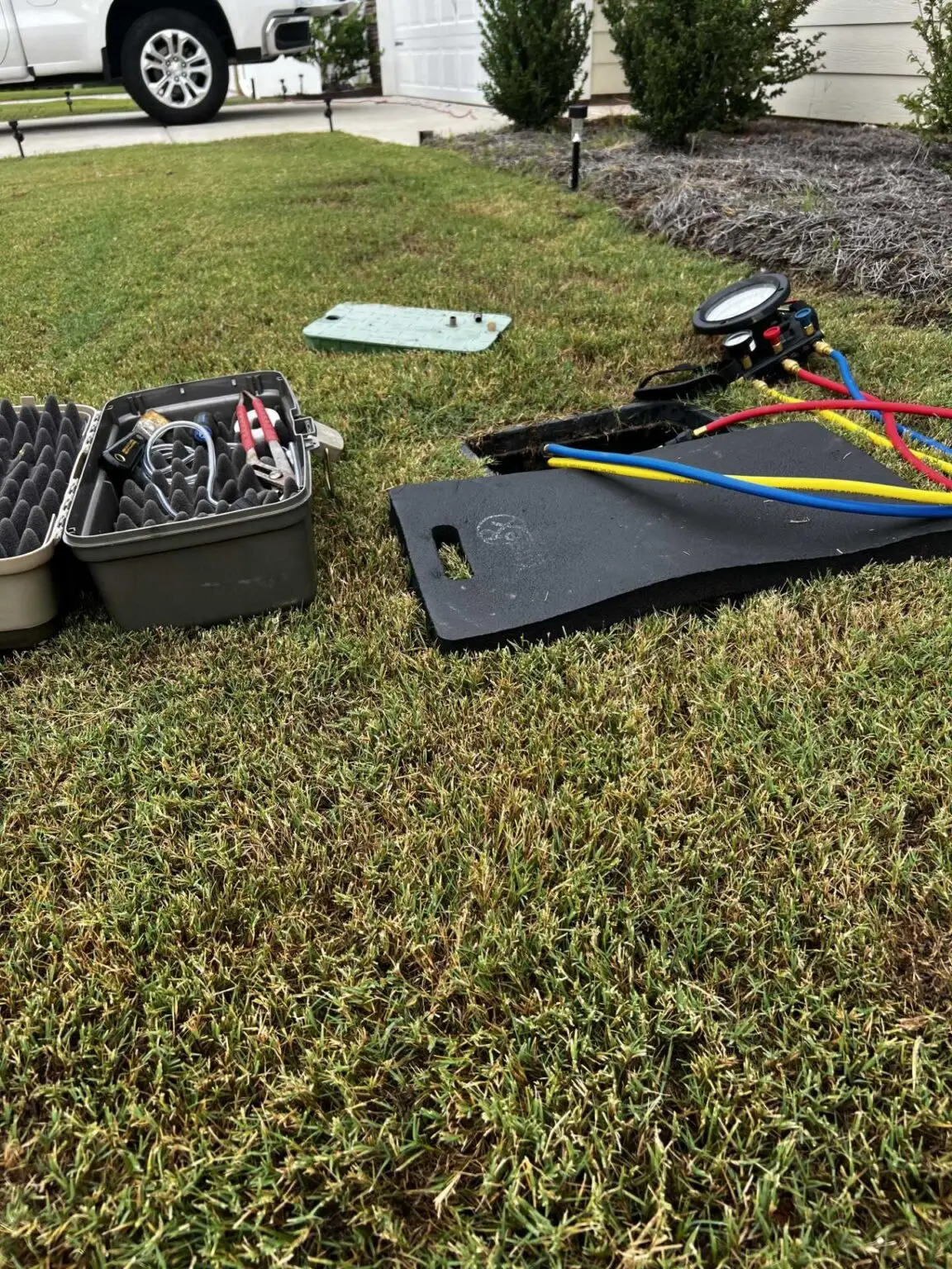 Backflow test kit and case set out on a lawn before a backflow prevention test