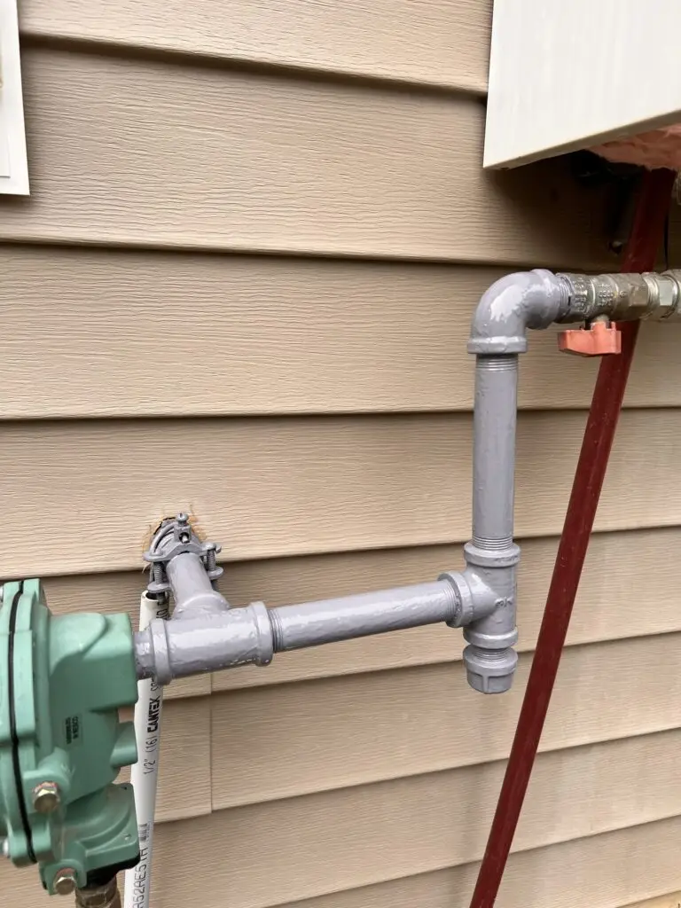 Gas supply line repainted gray to protect it from rust and weather