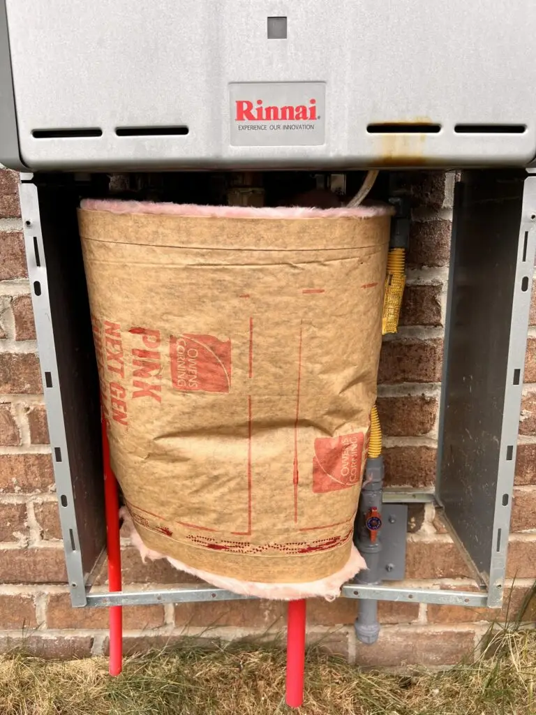 Outdoor Rinnai tankless water heater with new insulation fitted inside the pipe cover